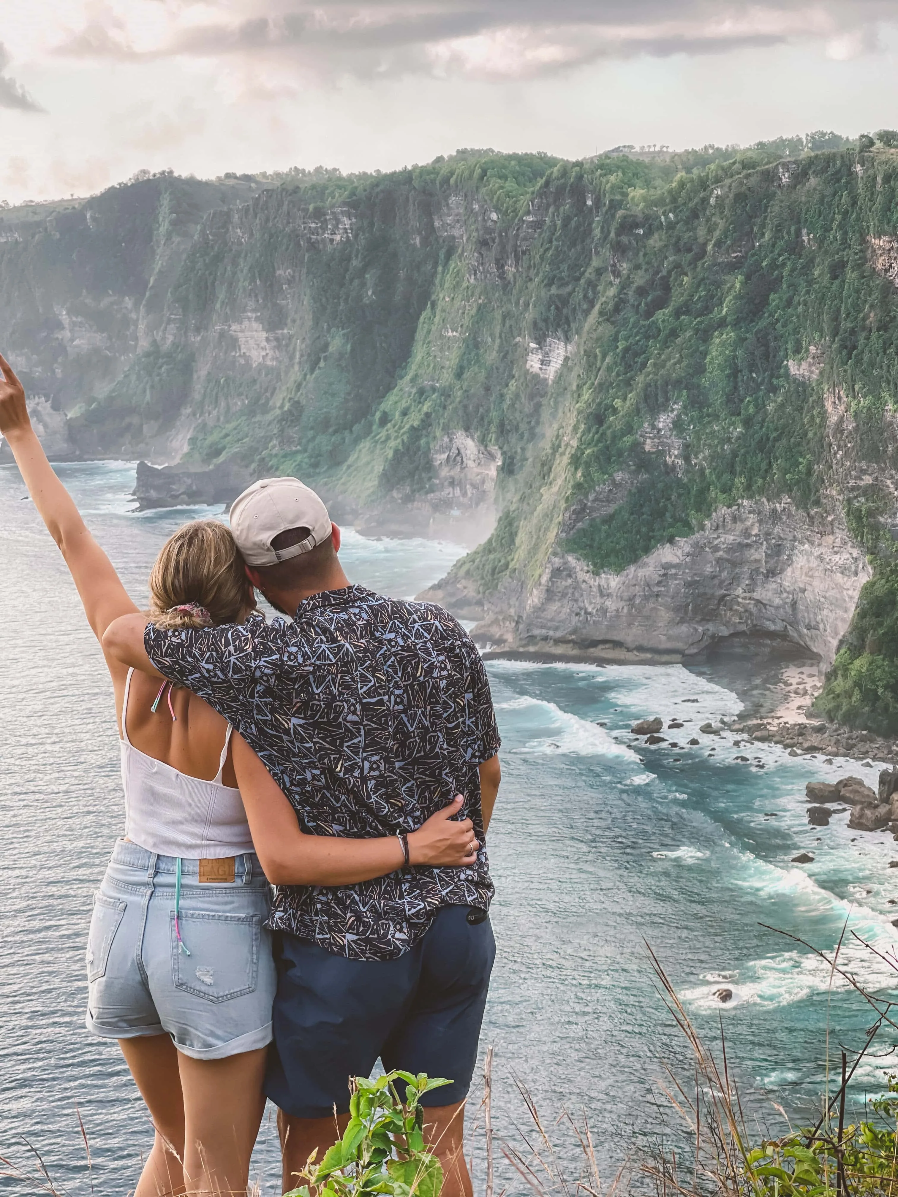 Couple facing the cliffs of Nusa Penida, Bali